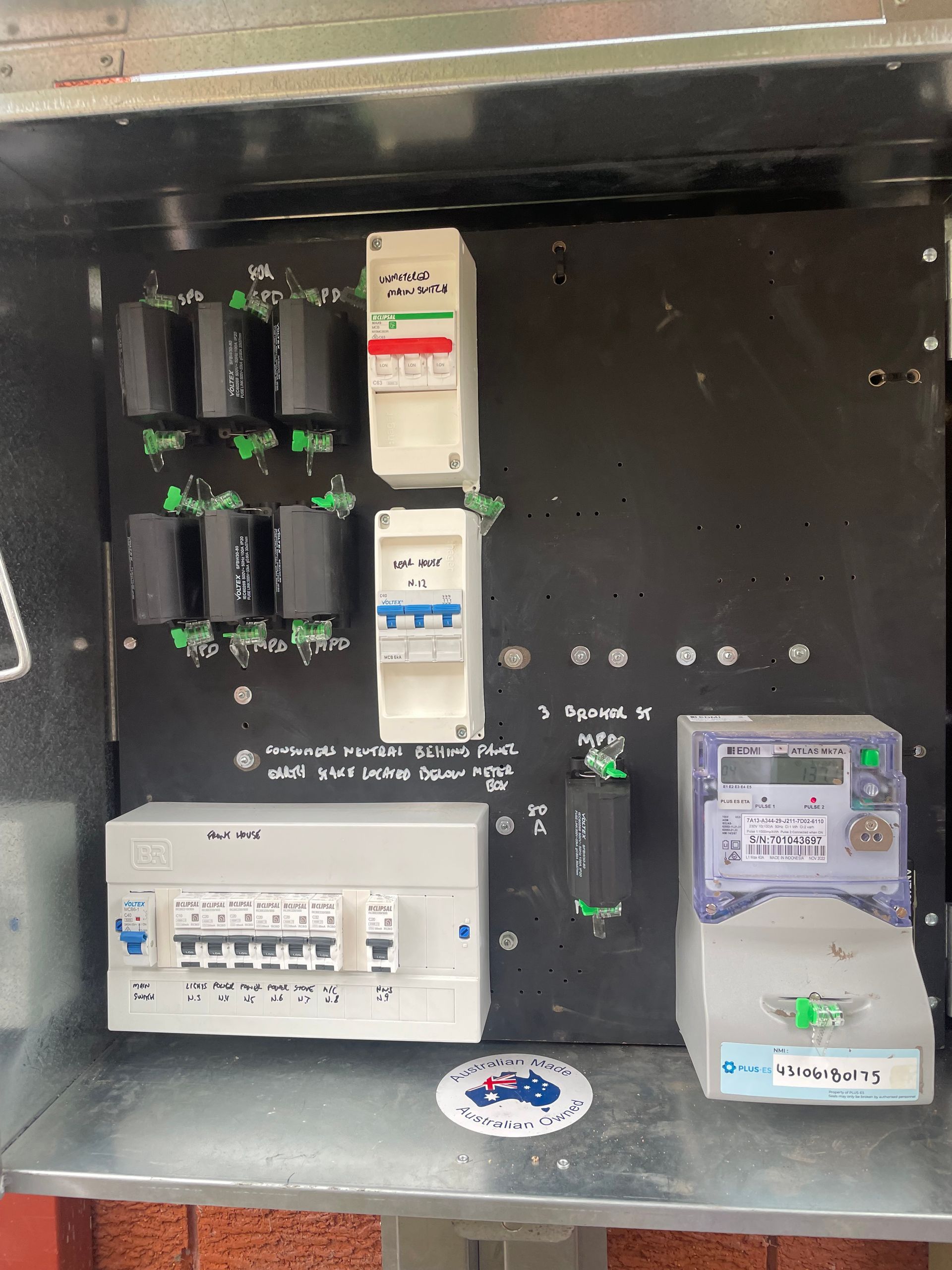 A Person Wearing Gloves Is Working On An Electrical Panel — Luke Jones Electrical In Bellambi, NSW