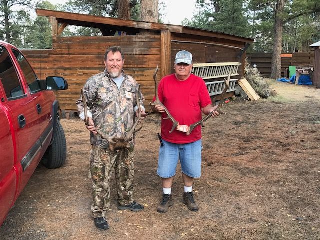 men showing off deer antlers