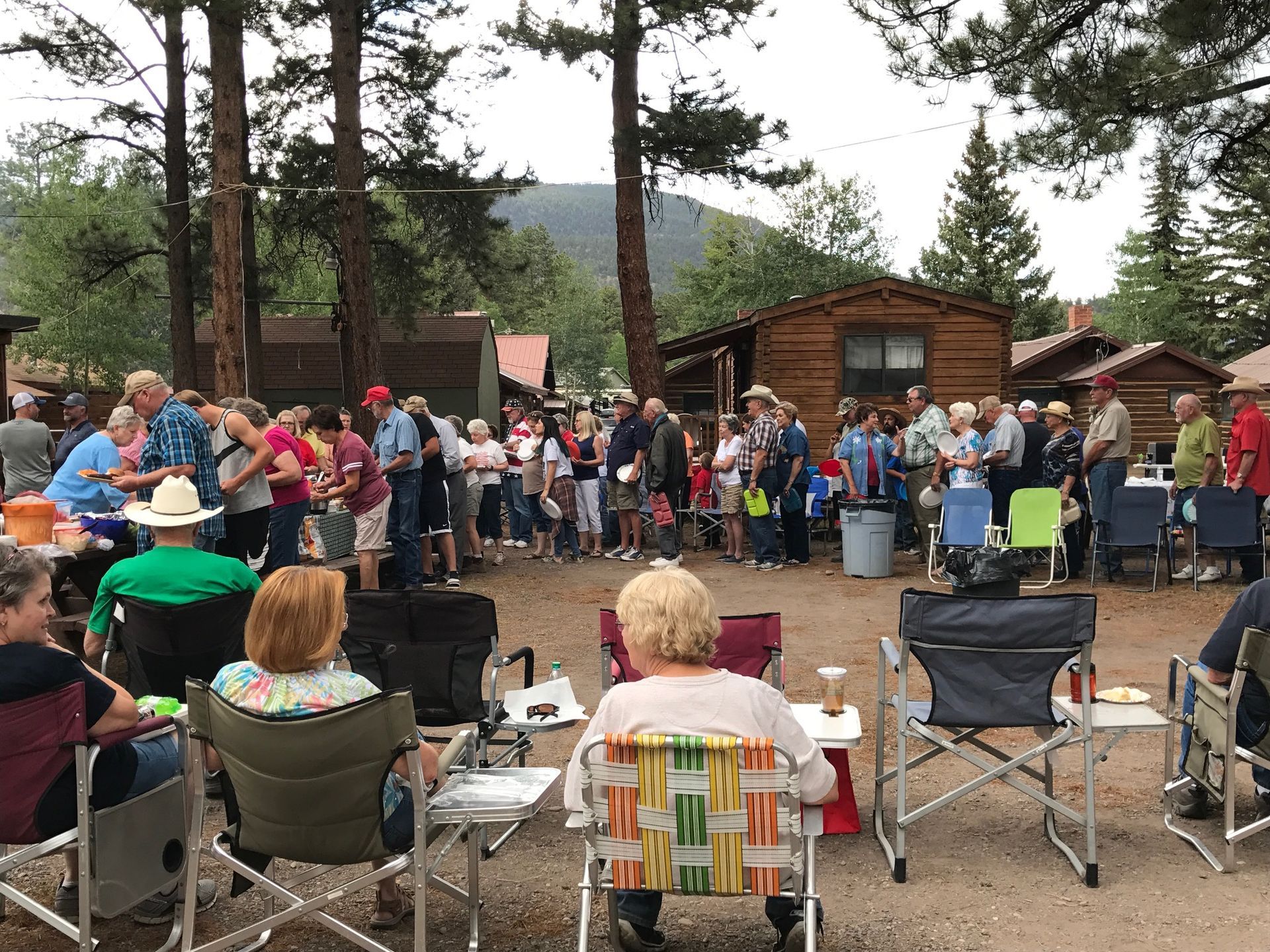 people gathered in lawn chairs