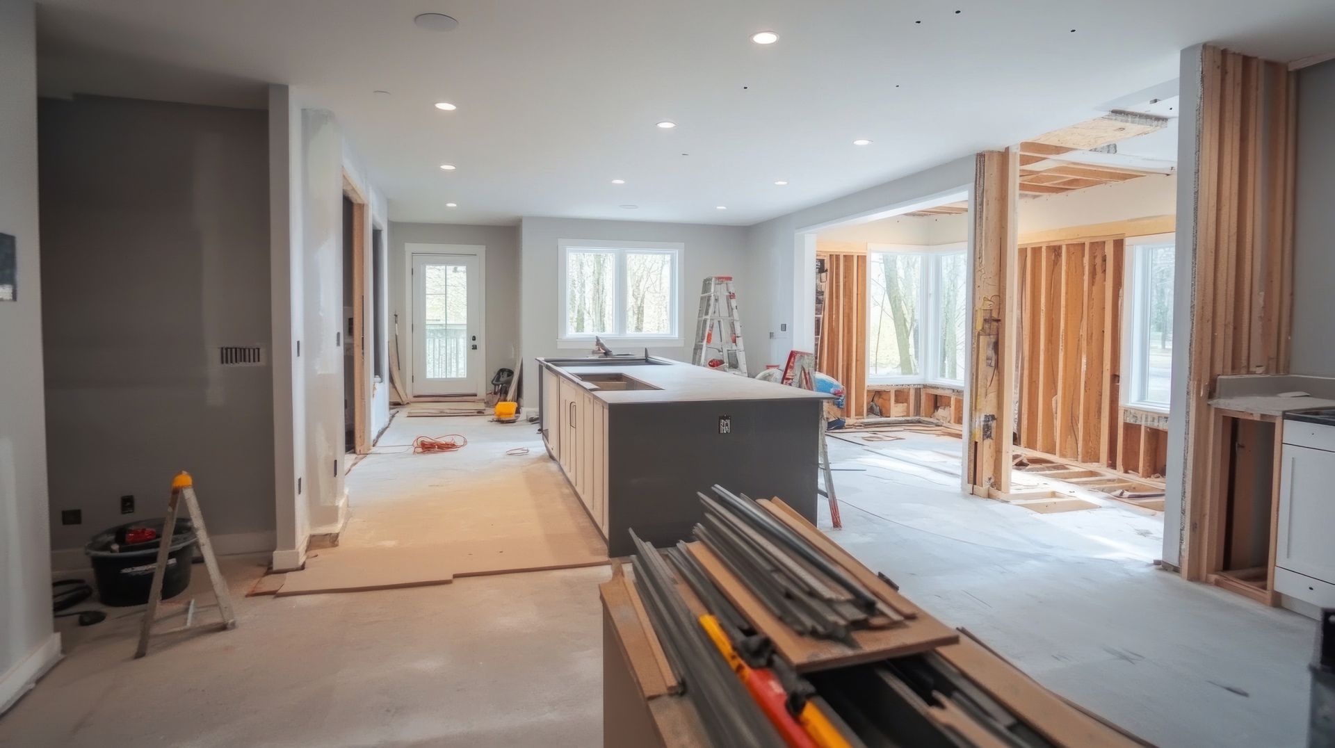 A kitchen and living room in a house under construction.