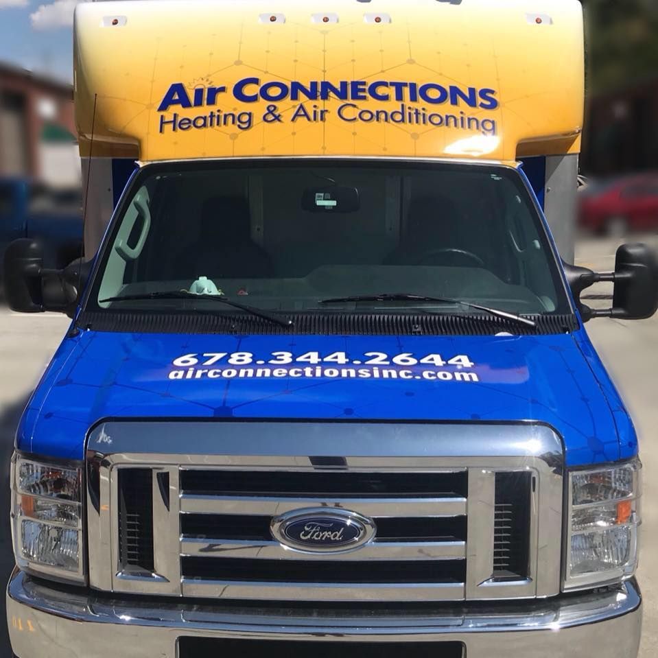 A blue ford truck with air connections heating and air conditioning written on it