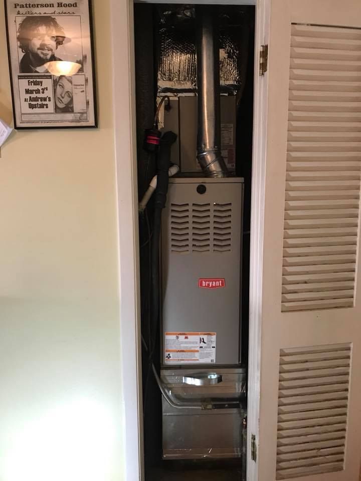 Air Connections Inc - An air conditioner is sitting inside of a closet.