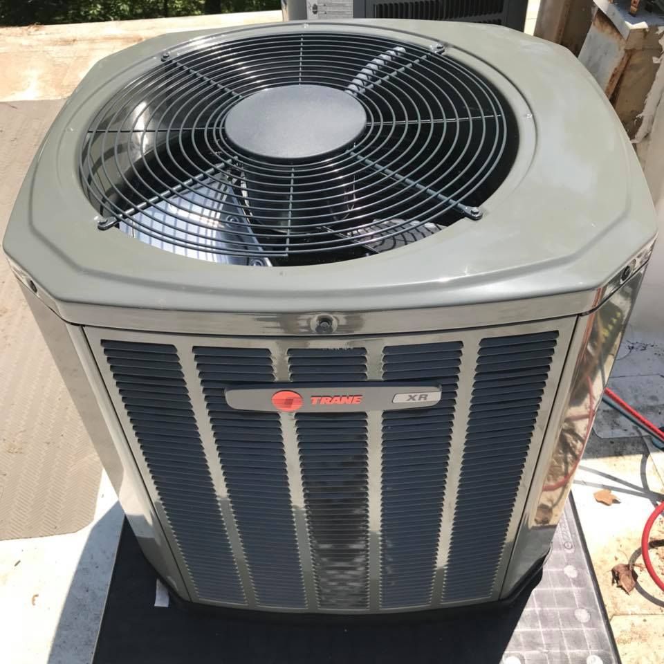 Air Connections Inc - A trane air conditioner is sitting on the ground