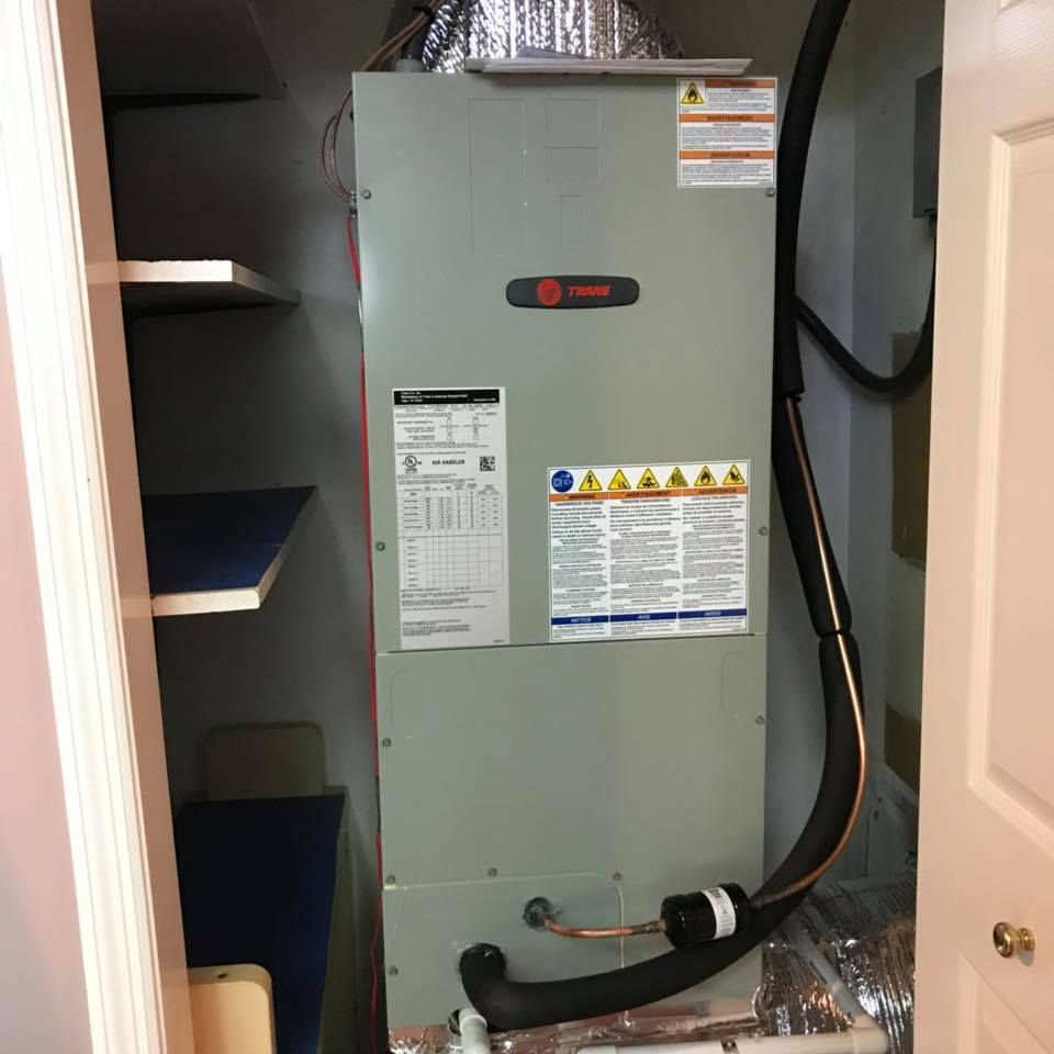 Air Connections Inc - A trane air conditioner is sitting in a closet