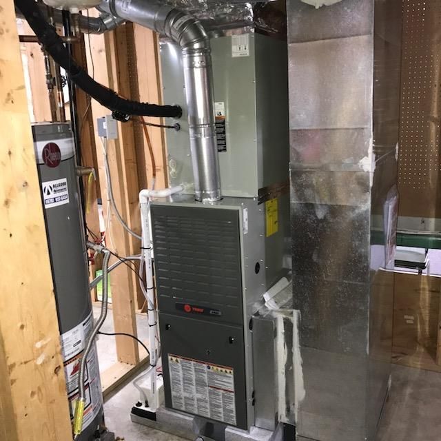 Air Connections Inc - A room with a heater and a water heater