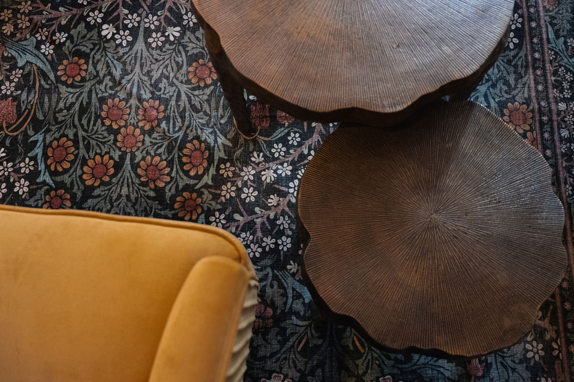 close up of floral rug in seating area, dark background, intricate flower design like a painting