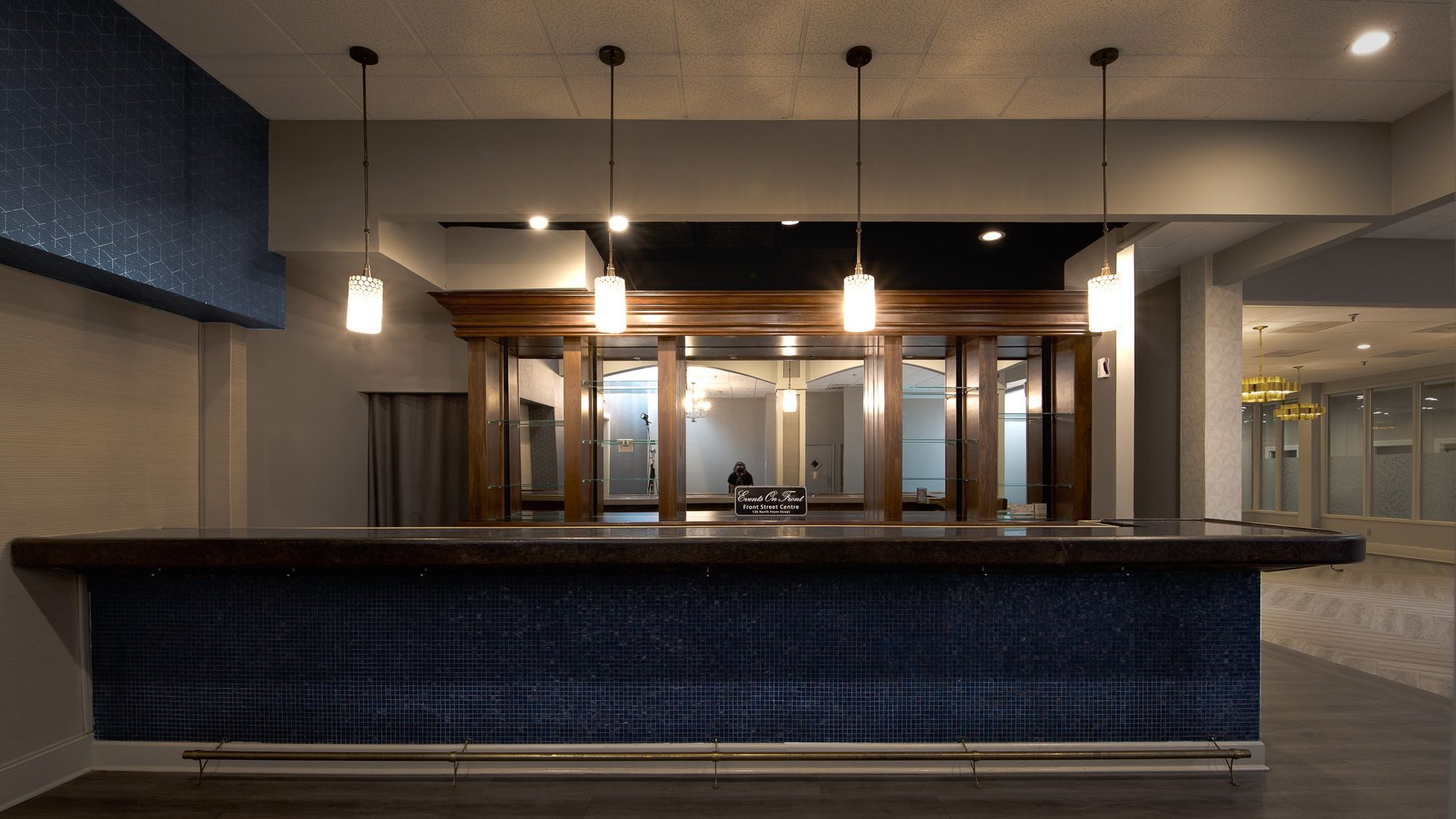 18 foot bar with striking blue tile and mirrors against back wall