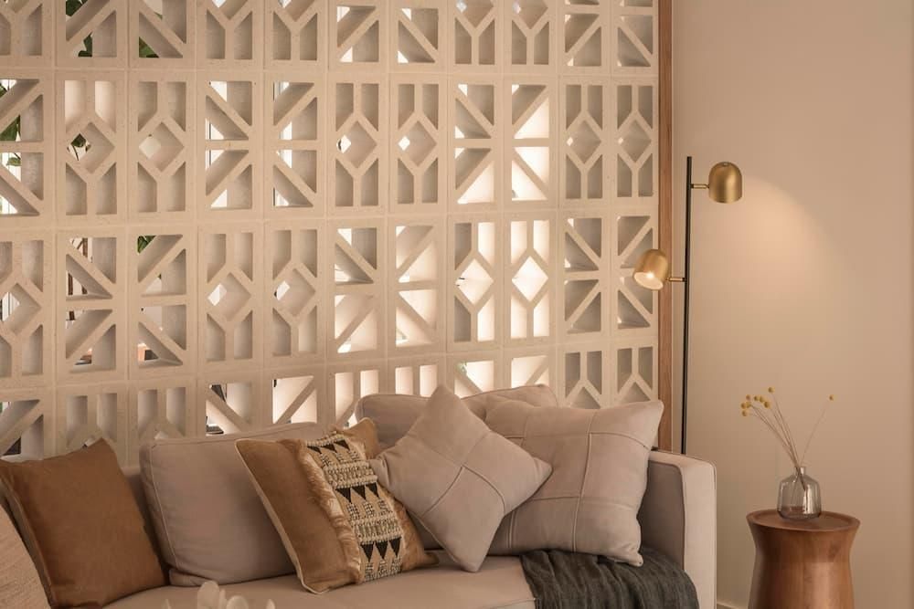 A Living Room With A Couch And Pillows And A Lamp — Southern Bricks & Pavers In Ulladulla, NSW