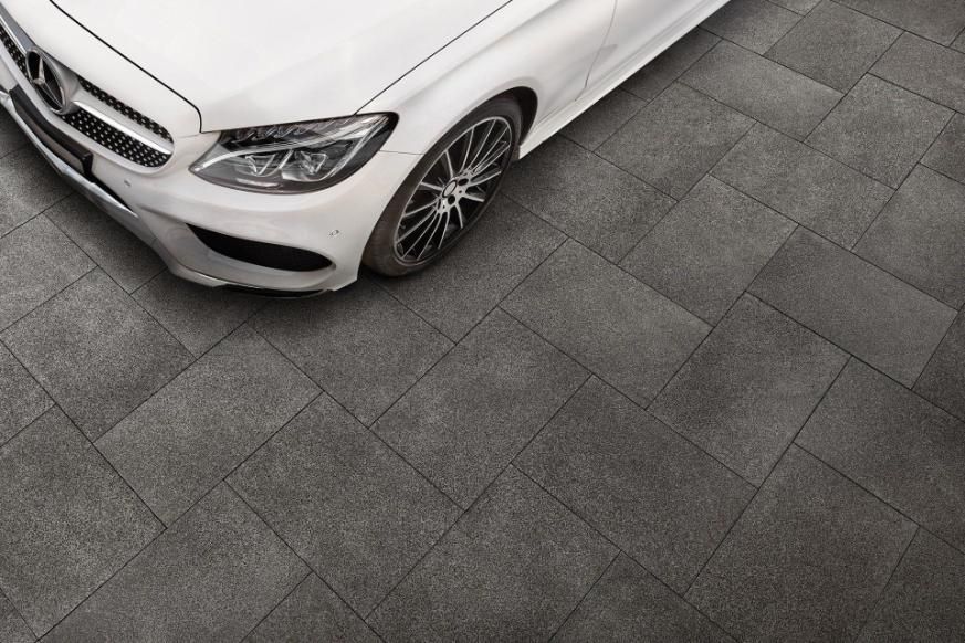A White Car Is Parked On A Tiled Floor — Southern Bricks & Pavers In Ulladulla, NSW