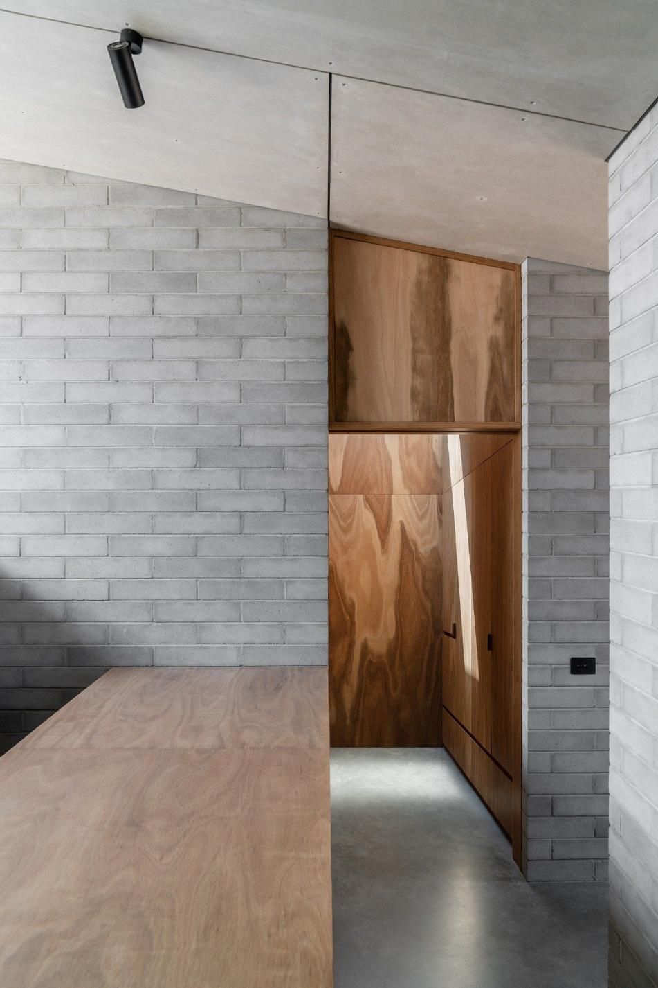 A Room With A Wooden Table And A Brick Wall — Southern Bricks & Pavers In Ulladulla, NSW