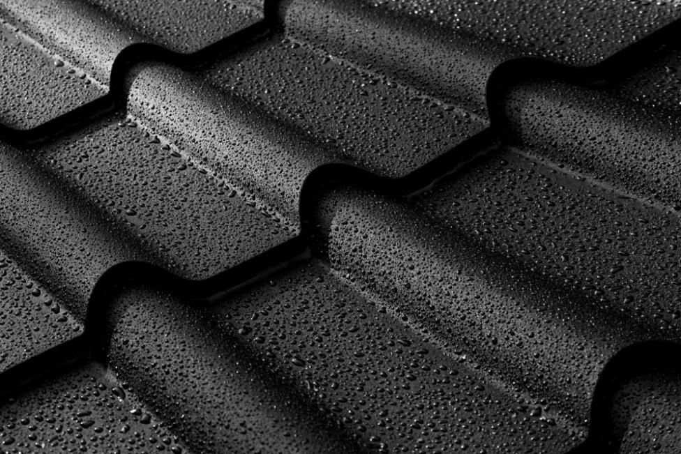 A Close Up Of A Black Roof With Water Drops On It — Southern Bricks & Pavers In Moruya, NSW