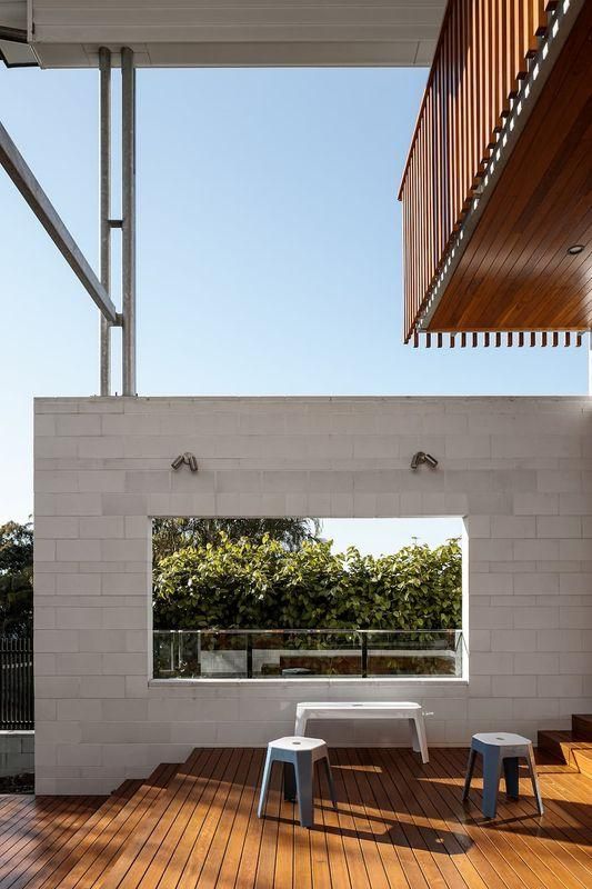 A Wooden Deck With A Table And Stools In Front Of A Window — Southern Bricks & Pavers In Ulladulla, NSW