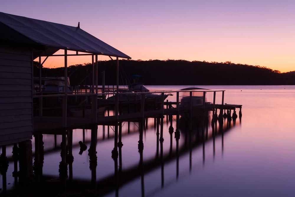 A Dock With A Purple Sky In The Background — Southern Bricks & Pavers In Narooma, NSW