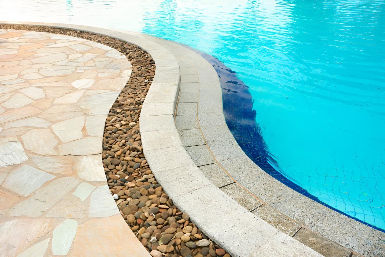 A Swimming Pool With a Stone Walkway Leading to It — Southern Bricks & Pavers In Ulladulla, NSW