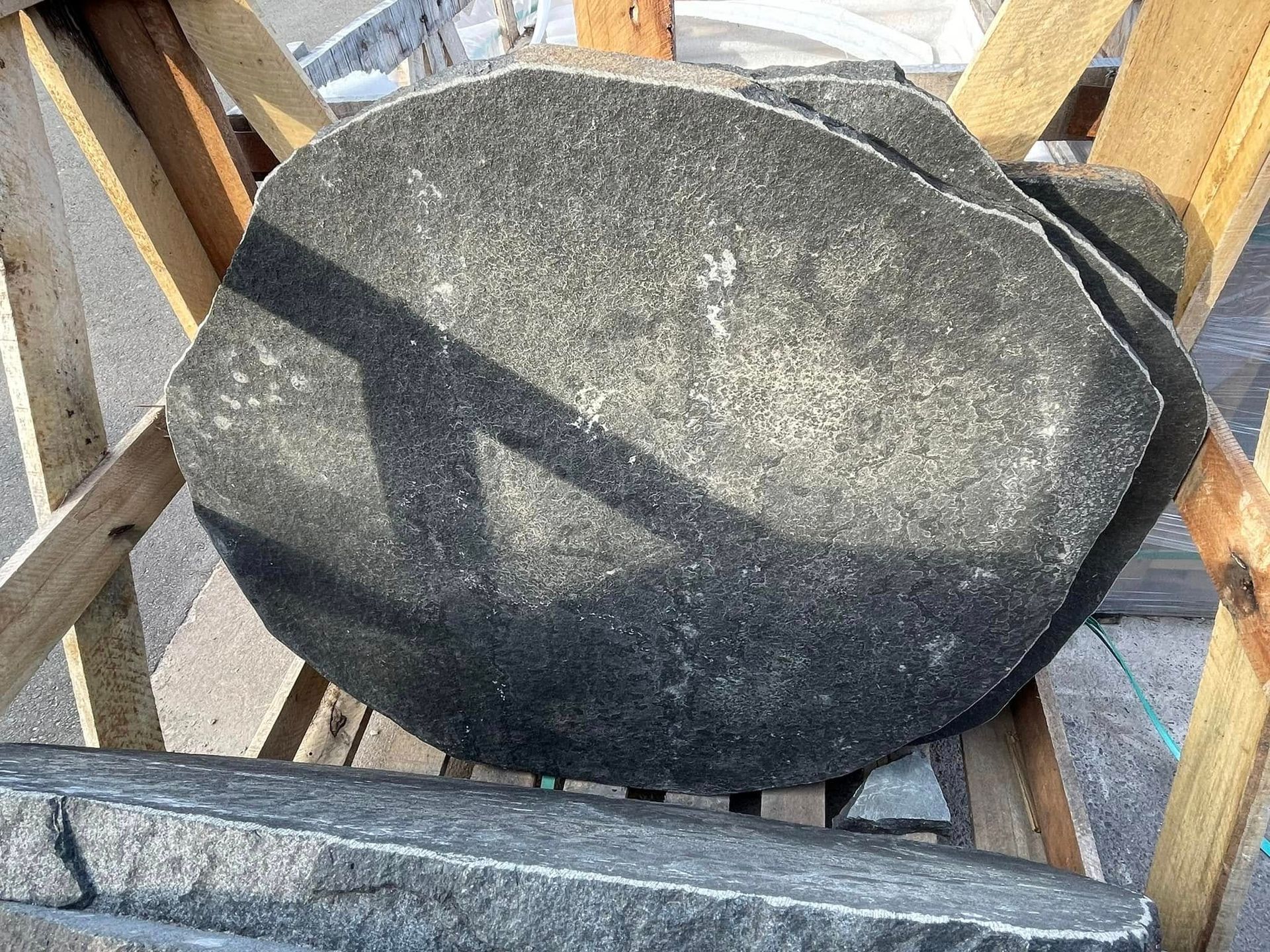 A Stack of Rocks Sitting on Top of Each Other on a Wooden Shelf — Southern Bricks & Pavers In Ulladulla, NSW