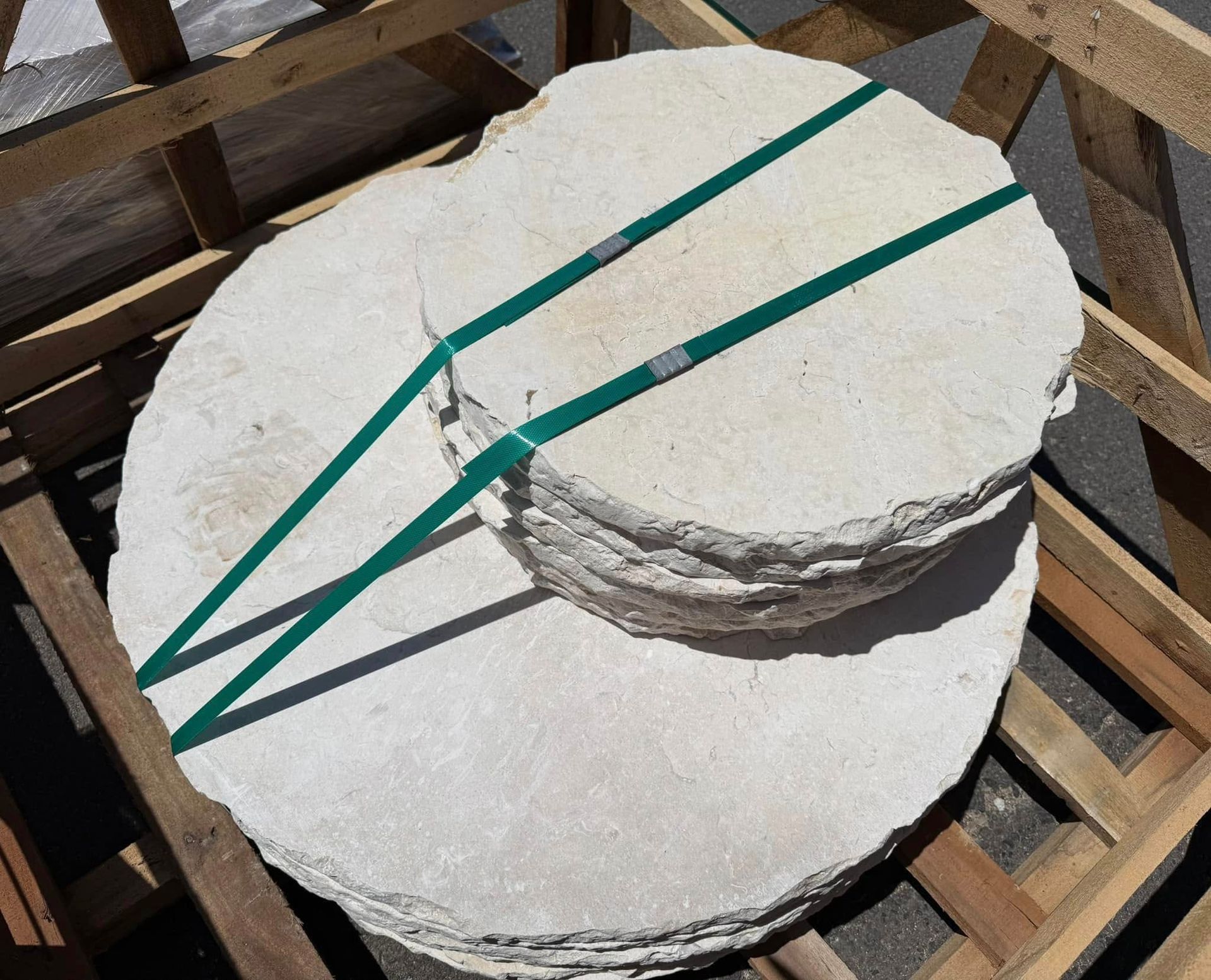 A Stack of White Circles Tied Together With Green Straps — Southern Bricks & Pavers In Ulladulla, NSW