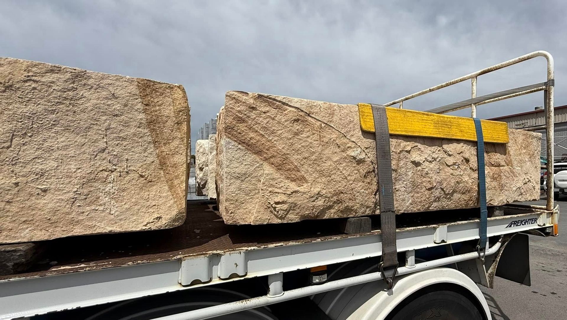 A Truck is Carrying Large Rocks on the Back of It — Southern Bricks & Pavers In Ulladulla, NSW