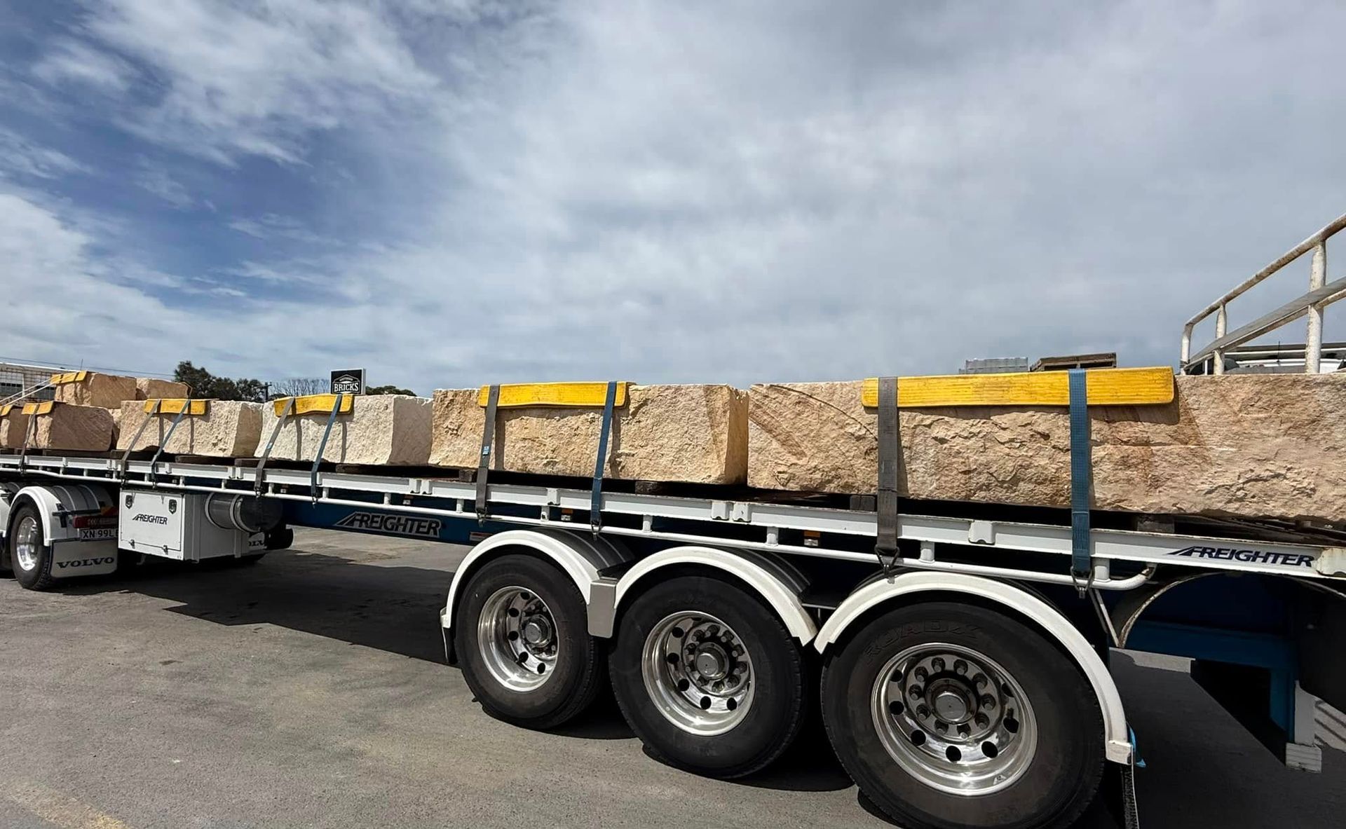 A Truck is Carrying a Large Load of Rocks on the Back of It — Southern Bricks & Pavers In Ulladulla, NSW