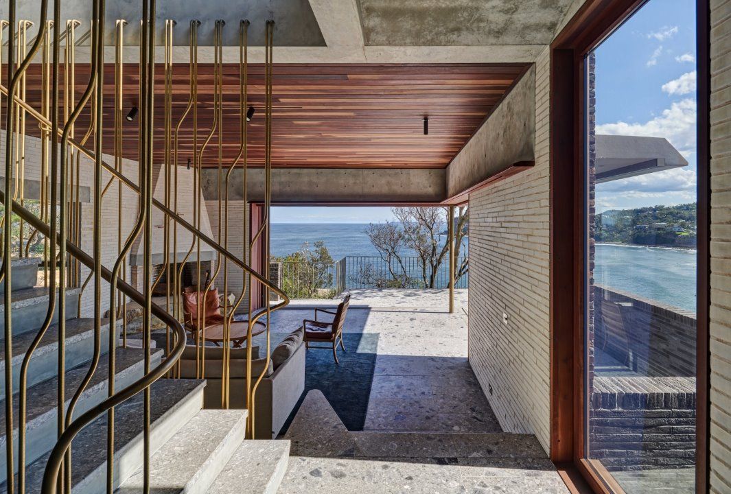 A Staircase Leading Up to a Living Room With a View of the Ocean— Southern Bricks & Pavers In Ulladulla, NSW
