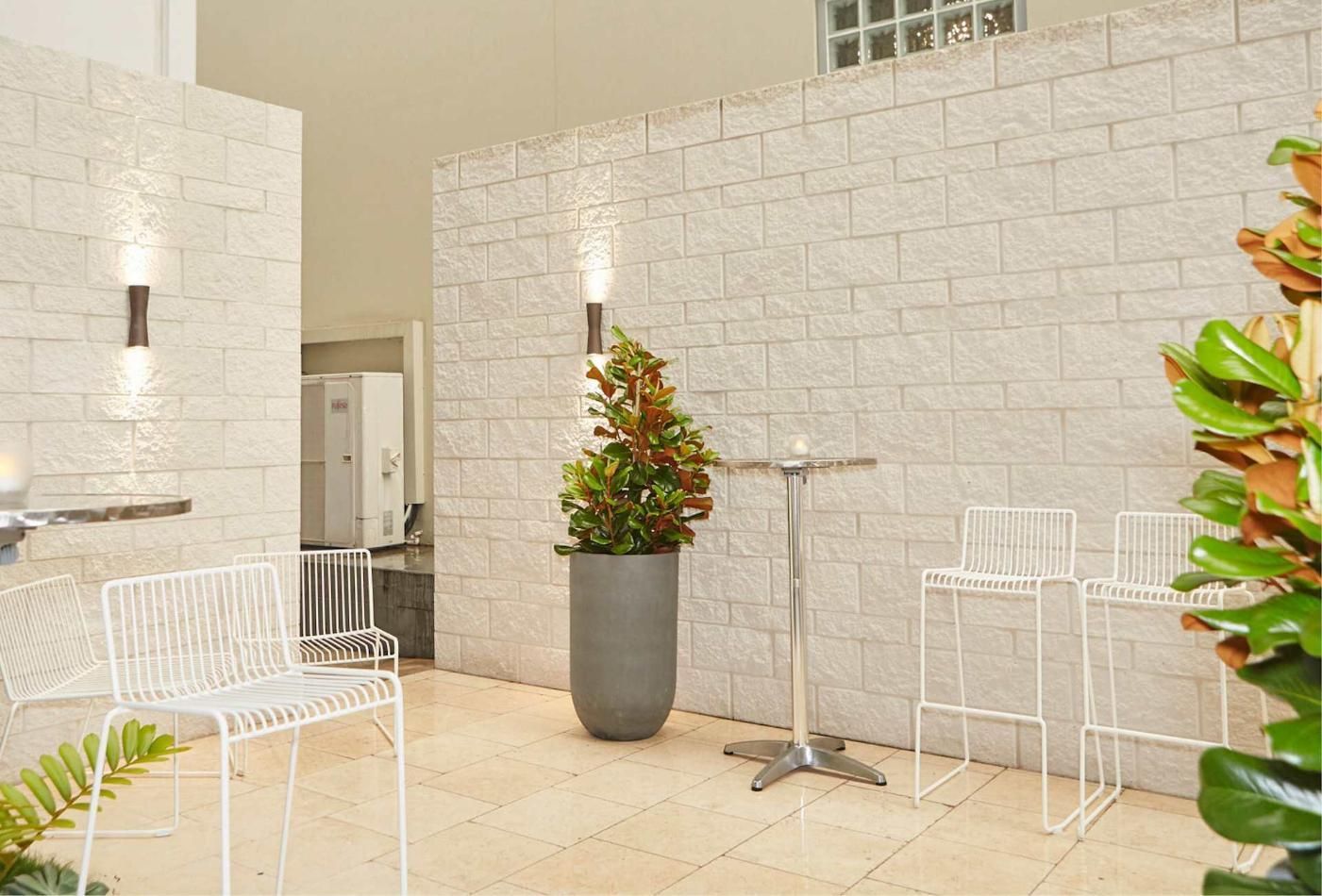 A Patio With Chairs, A Table And A Potted Plant — Southern Bricks & Pavers In Ulladulla, NSW