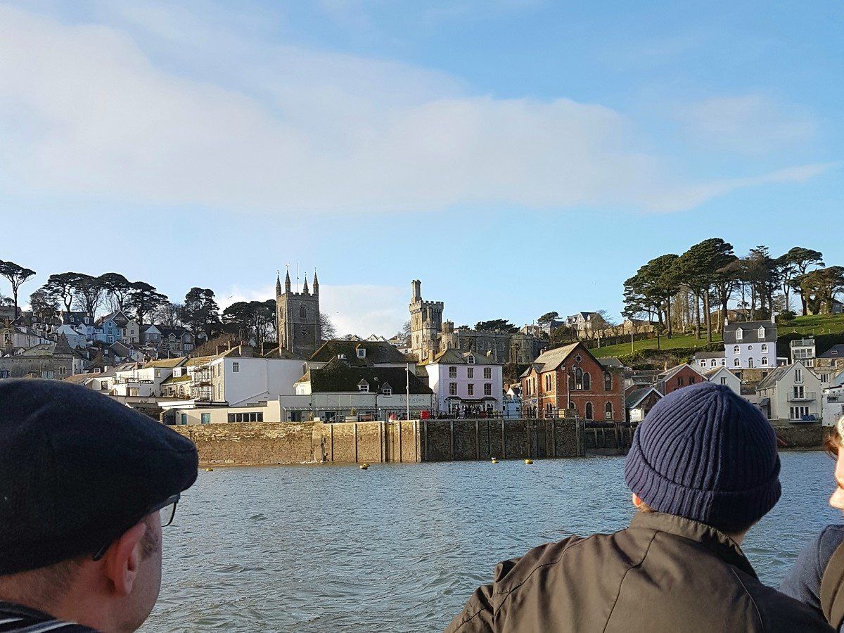 Looking from the passenger ferry across the water to Fowey, with ancient towers and waterside buildings