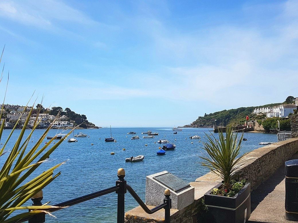 A fine day in Fowey estuary with boats moored under a blue sky