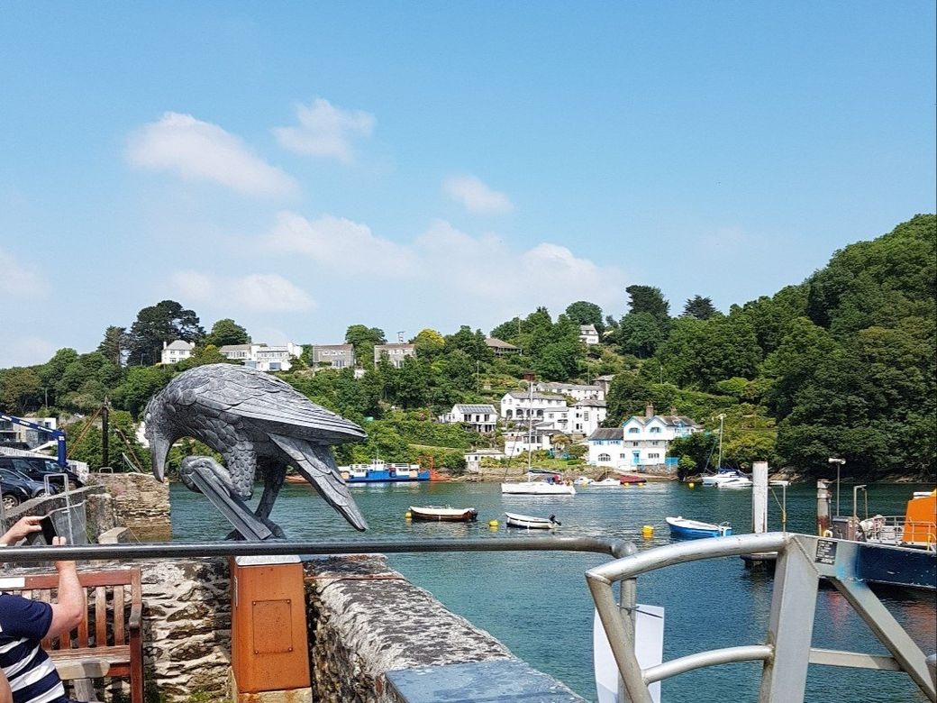 View up river from the Fowey side towards Bodinnick village scrambling up the opposite bank