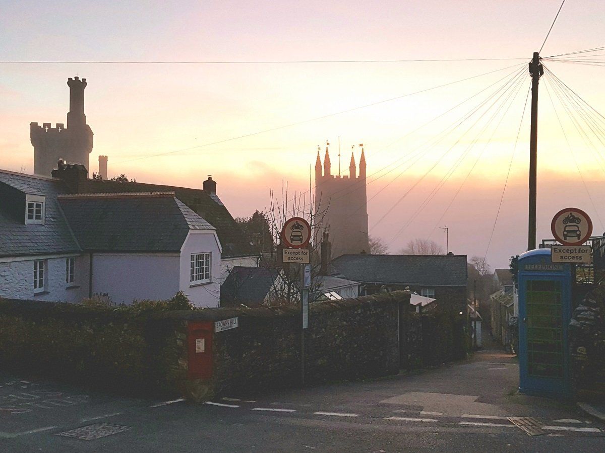 Misty sunrise shot of Fowey town and the church tower