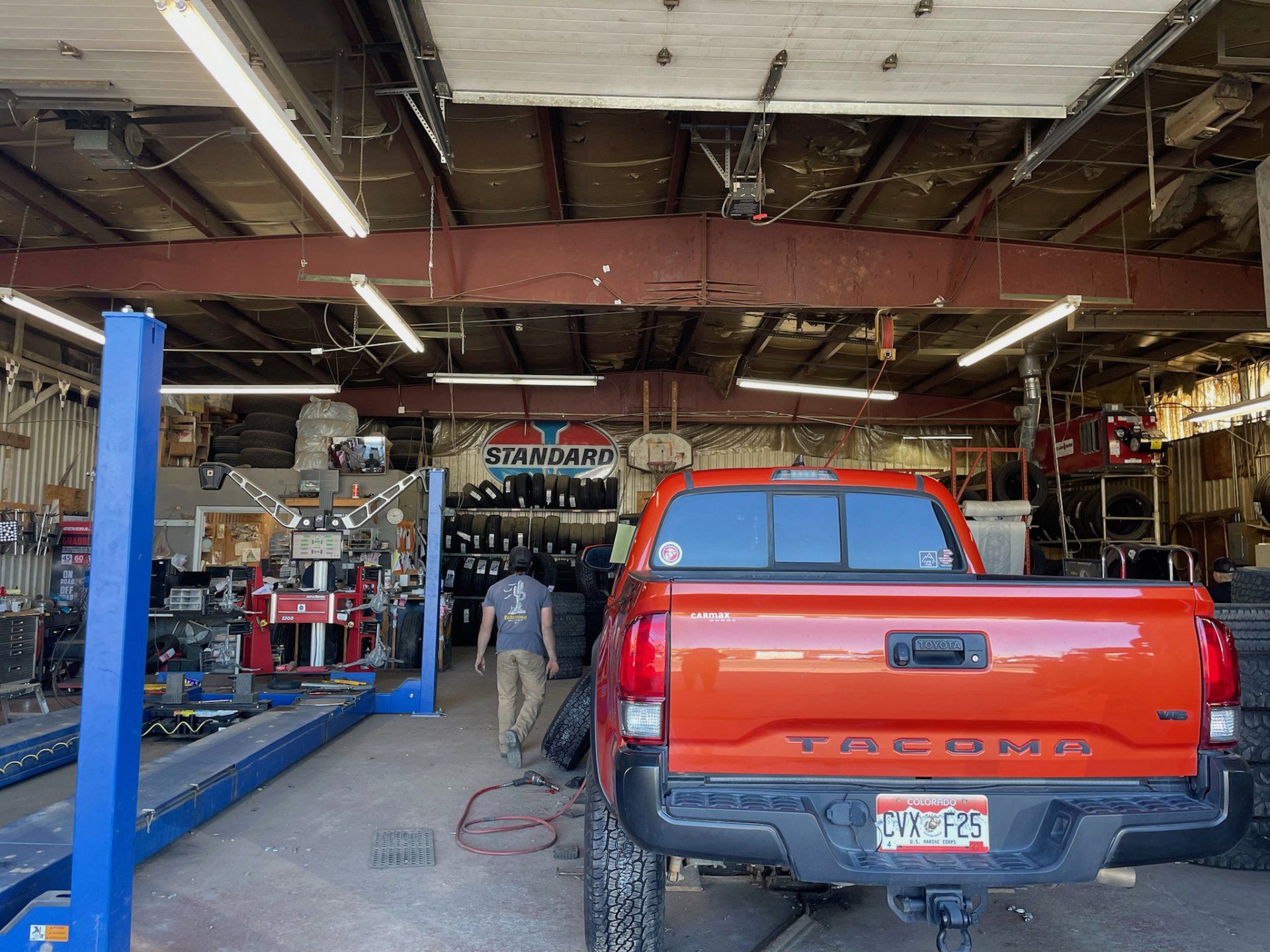 orange toyota in mechanic bay