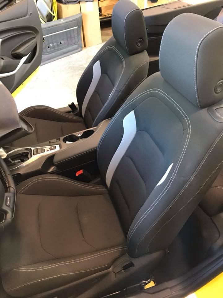 A close up of the seats of a yellow car