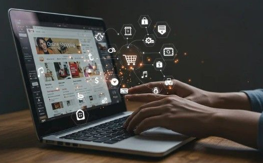 A laptop showing an online store with hands typing on the keyboard. Superimposed over the photo are different graphics showing the lifecycle of a customer (cart, money, music, car, etc.) 
