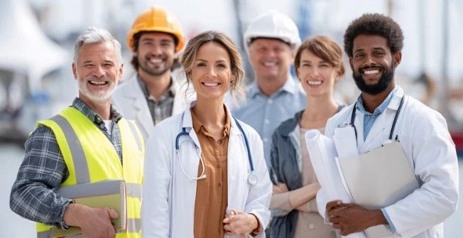 Group of diverse professionals smiling at the camera: construction worker, doctors, and architects.