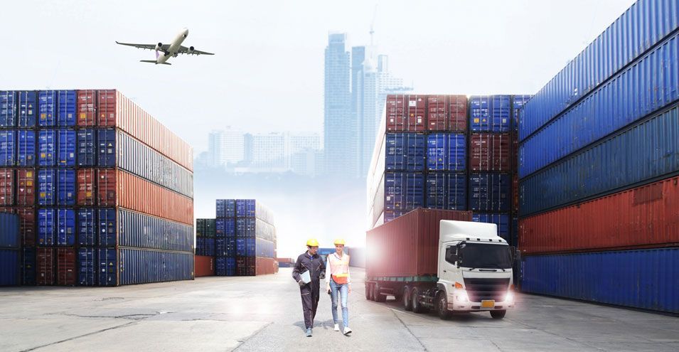 Shipping containers, truck, airplane, and two people walking in a port.