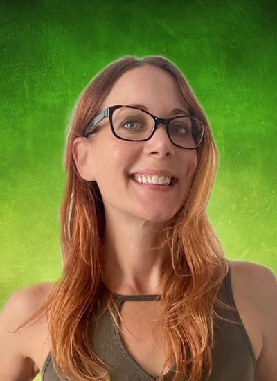Woman with red hair and glasses smiles. Green gradient background.