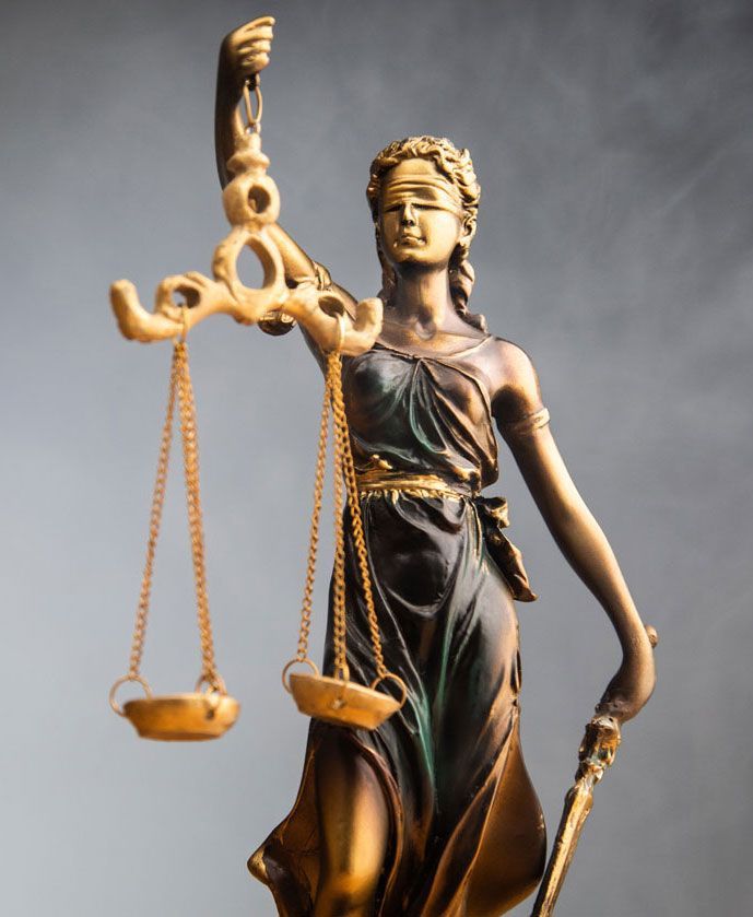 Statue of Lady Justice with scales and a sword, blindfolded.