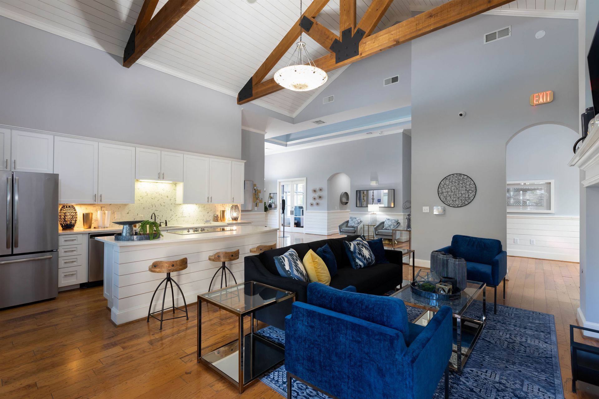 A living room filled with furniture and a kitchen in a house.