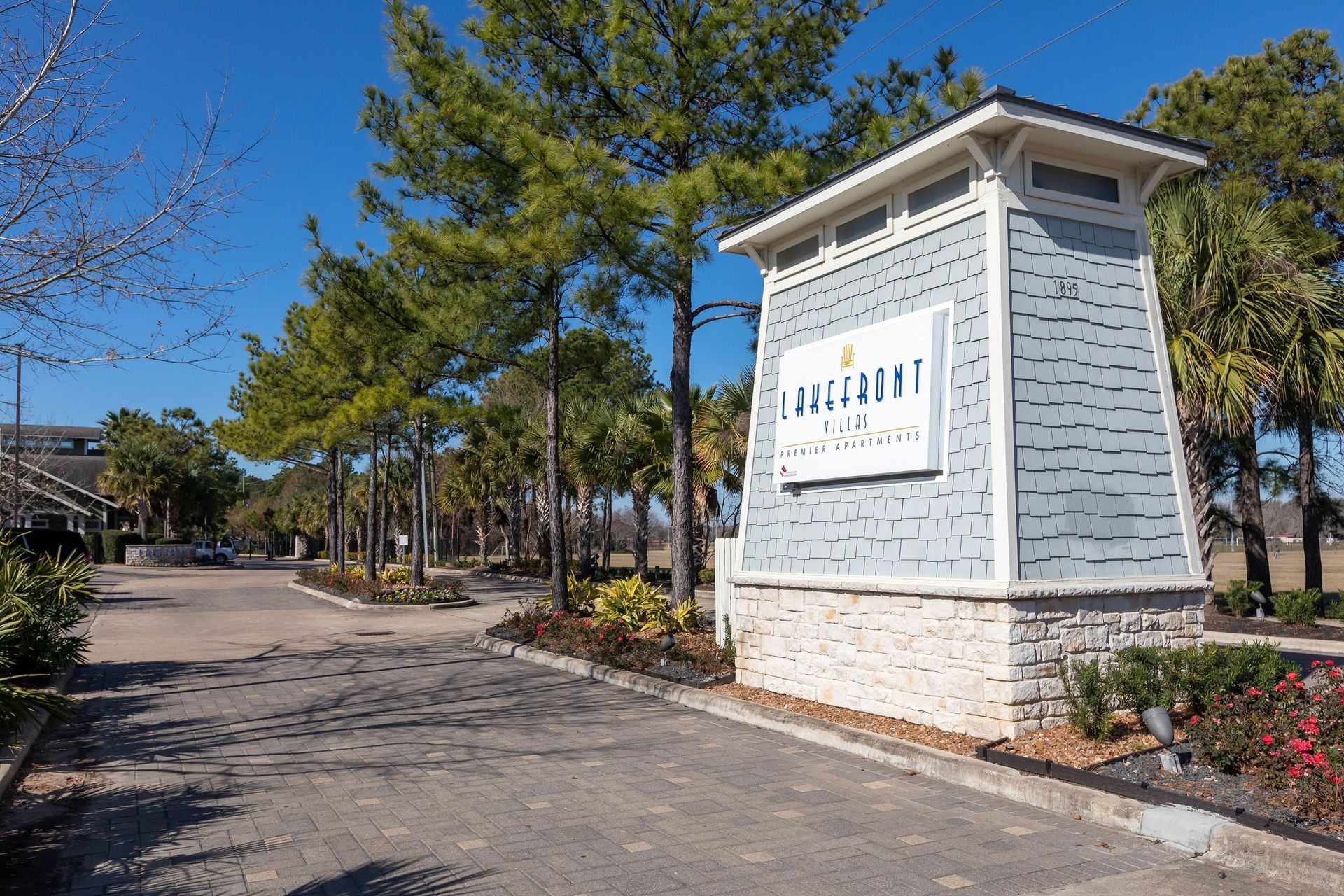A building with a sign on it is surrounded by trees.