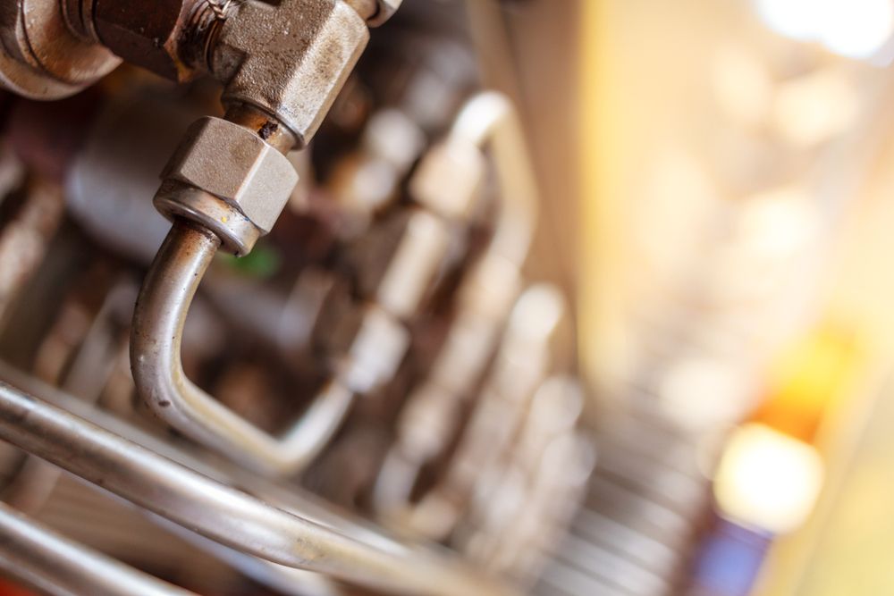 A Close Up of a Metal Oil Pipe on a Machine — Grafton Hydraulics in South Grafton, NSW
