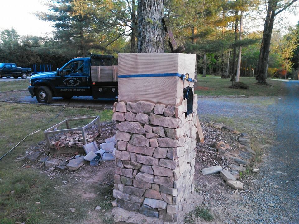 A truck is parked next to a stone pillar