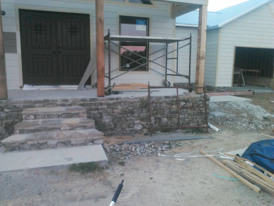 A house under construction with a scaffolding in front of it