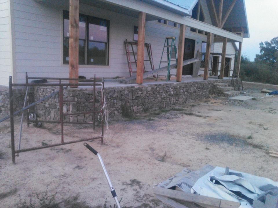 A house under construction with a scaffolding in front of it