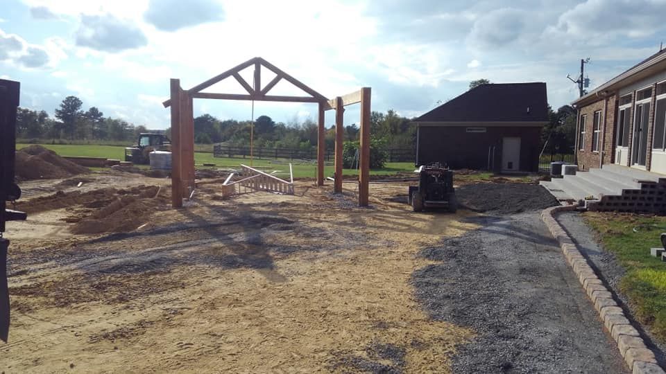A house is being built in the middle of a dirt field.