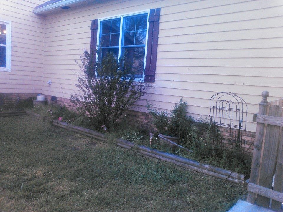 The backyard of a house with a fence and a window