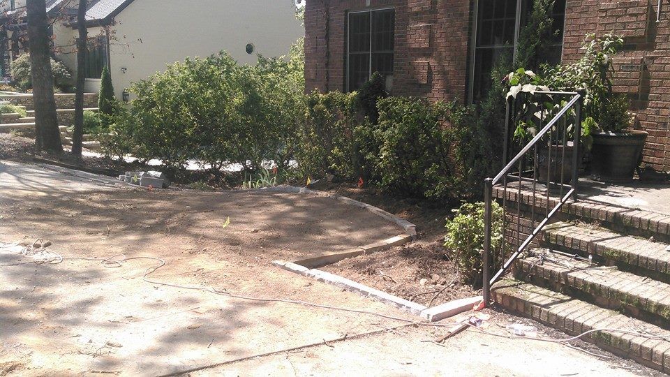 A brick house with a metal railing in front of it