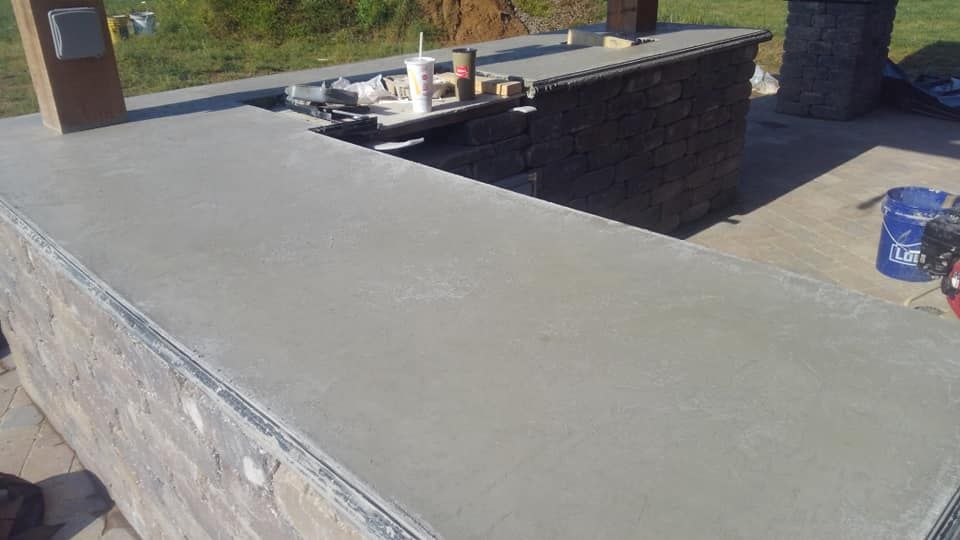 A concrete counter top is being built on a patio.