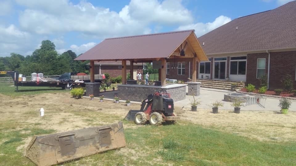 A tractor is parked in front of a large house.