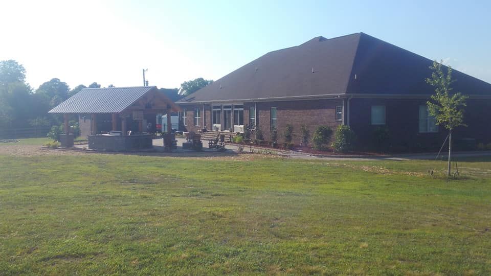 A large house with a large lawn in front of it.