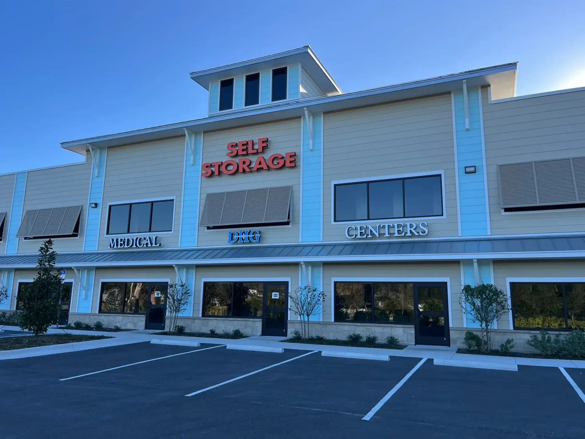 Crane lifting a large tilt-wall concrete panel near a building under construction in Port Orange Florida.