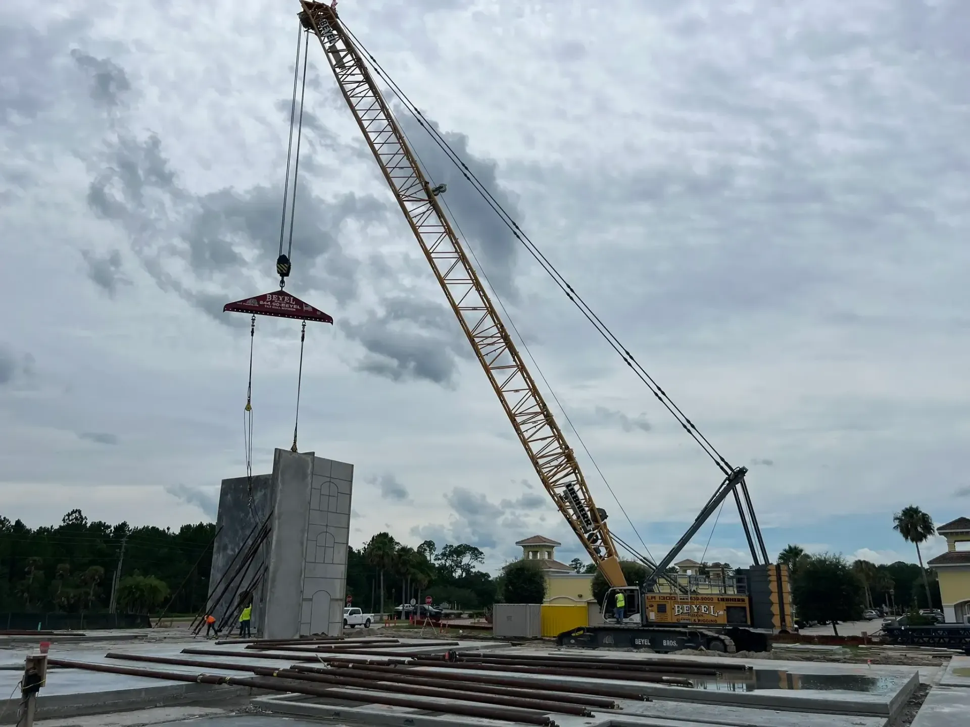 Concrete slab construction site at night, showing rebar grid, wooden forms, and pump truck.