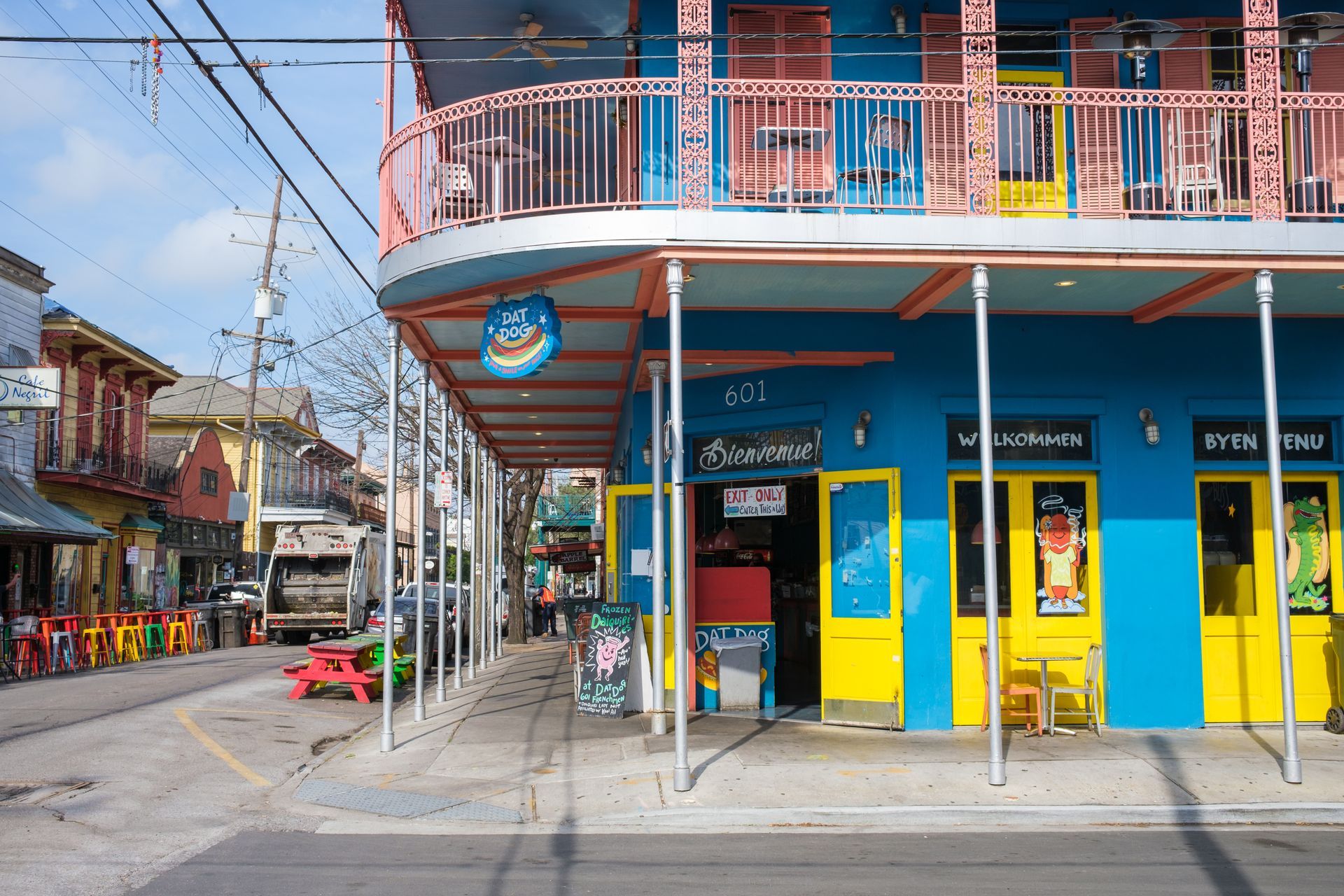 A blue and yellow building with a balcony on the side of it.